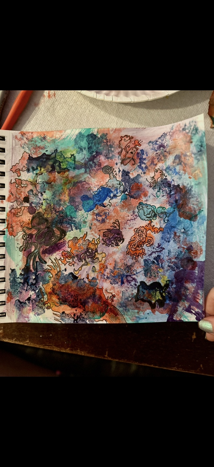 Sketchbook page of layered colorful paint with little figures and forms outlined in the shapes
